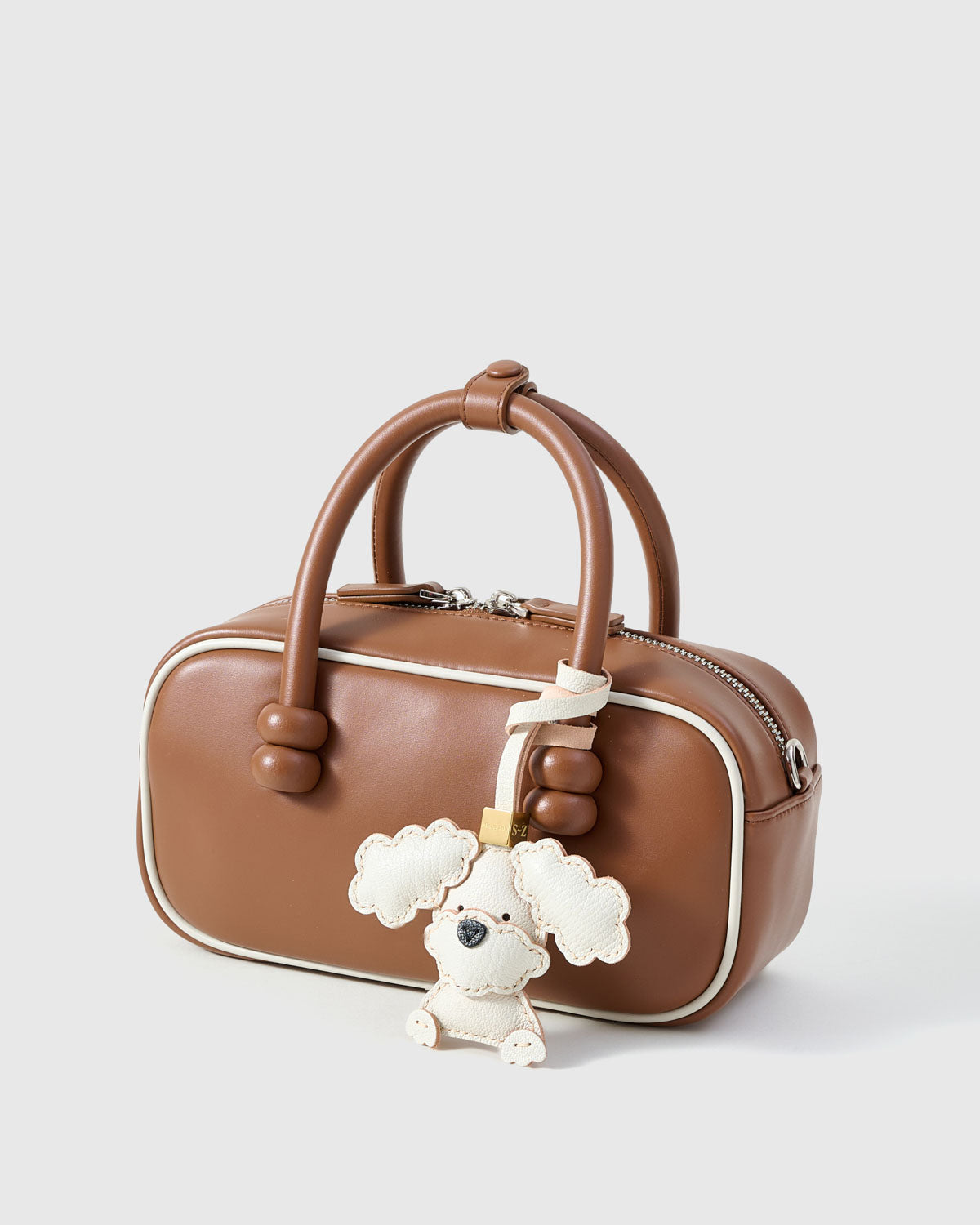 Handmade Poodle leather bag charm — French Alran goatskin from a tannery founded in 1903 in Tarn, France. STICKYZOO.