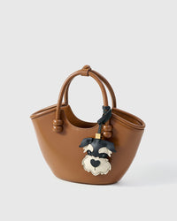 The schnauzer charm is made from genuine French Alran goatskin and French suede — real full-grain leather. Never vegan. Never synthetic. The difference shows.