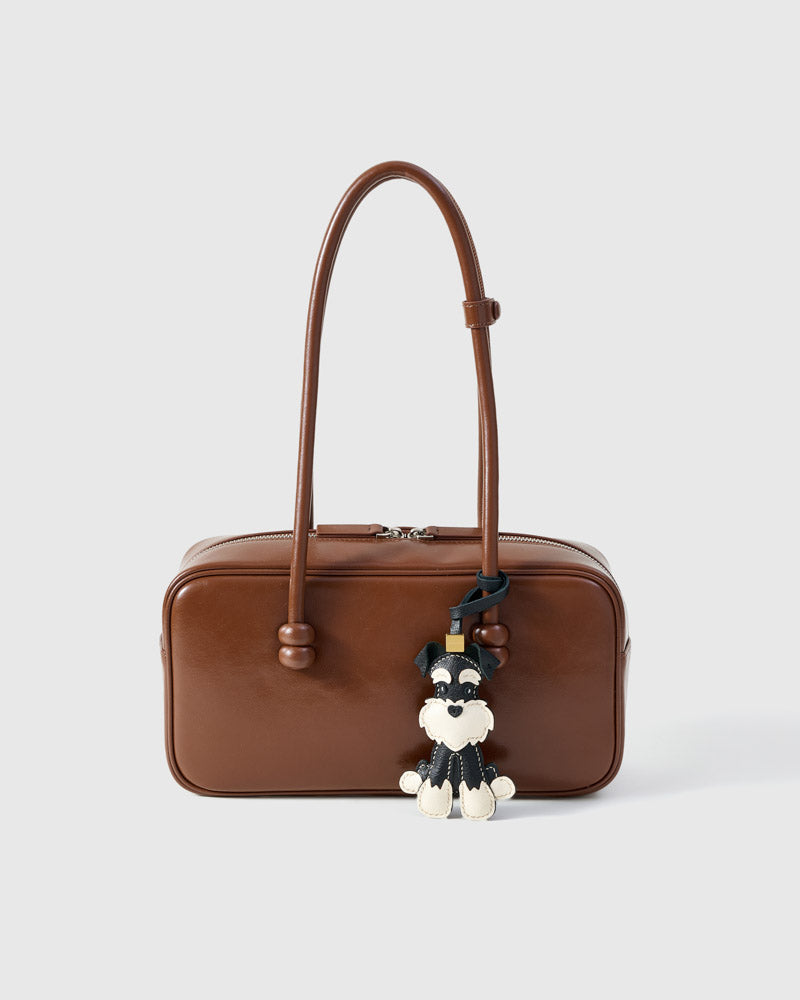 Wear the black urban schnauzer charm on a bag with the leather strap loop, or clip it to keys with the 18K gold-plated keychain clip.
