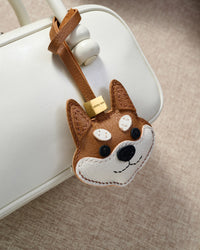 Every panel of the orange Tokyo Shiba charm is cut by hand and stitched through real French leather. Layered slowly for depth — no prints, no stamps.