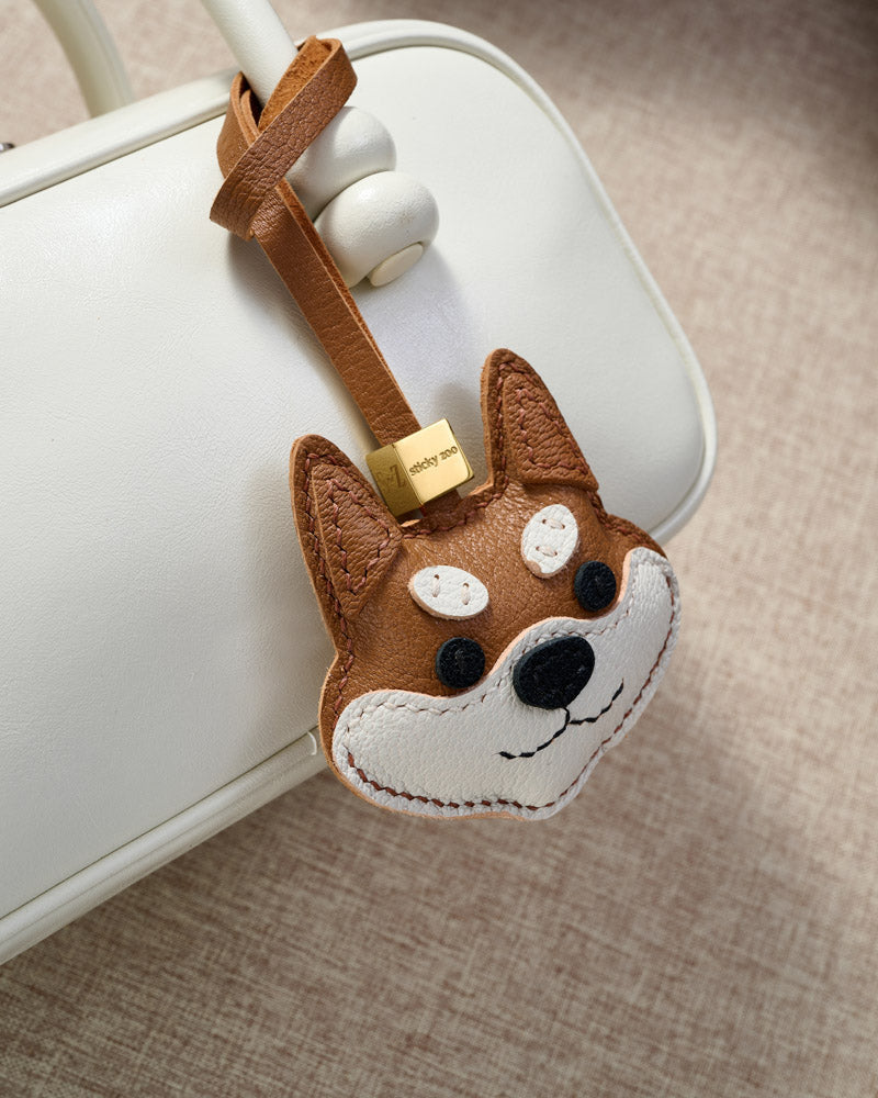 Every panel of the orange Tokyo Shiba charm is cut by hand and stitched through real French leather. Layered slowly for depth — no prints, no stamps.