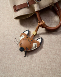 FOX CHARM charm styled on a bag — a small, specific piece that turns a simple bag into a personal one.