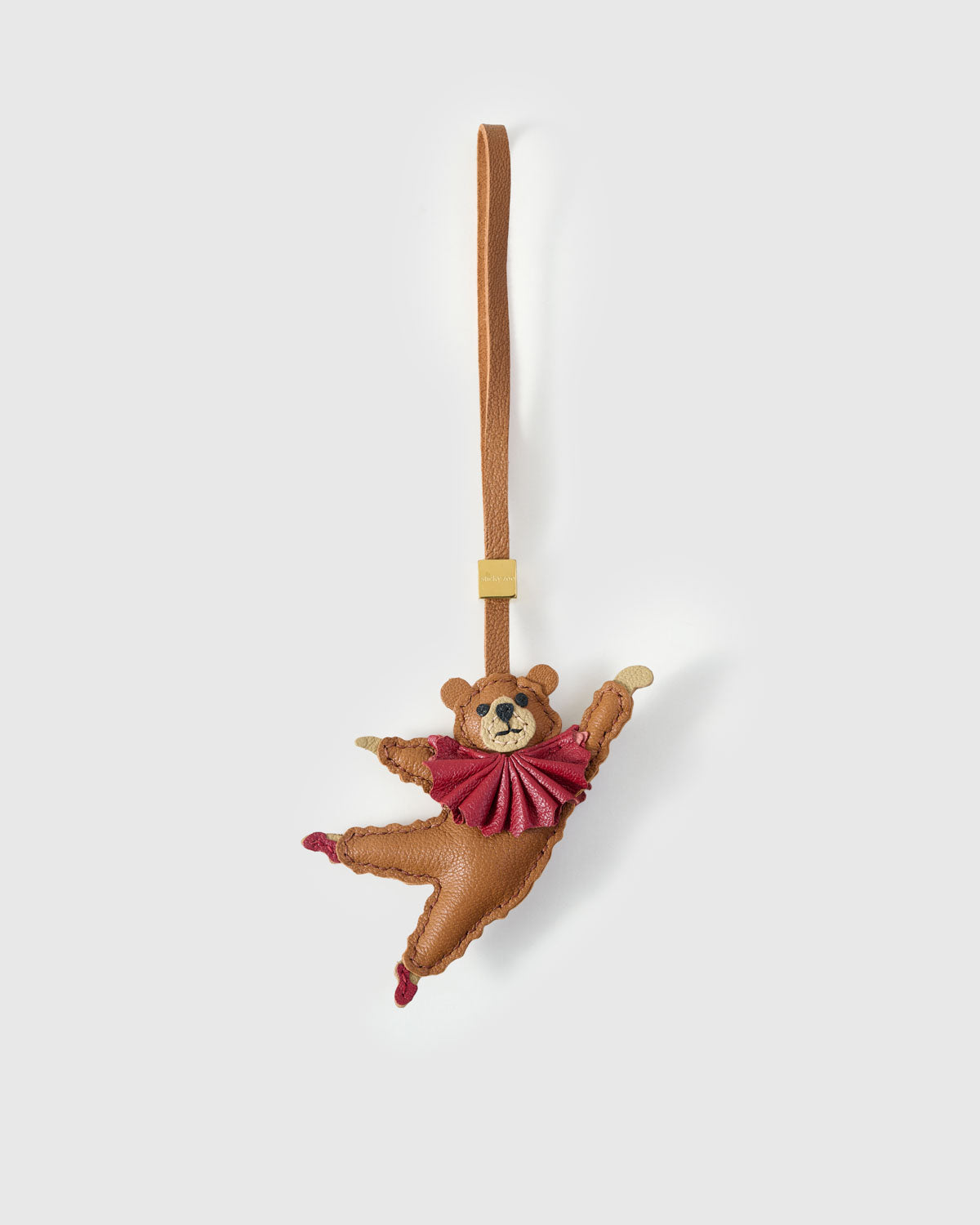 BALLET BEAR CHARM charm handmade from French Alran genuine goatskin — A caramel bear in a rose-pink tutu, mid-leap, smiling. One. Three days by hand. Arrives in luxury gift packaging. Designed in Amsterdam.