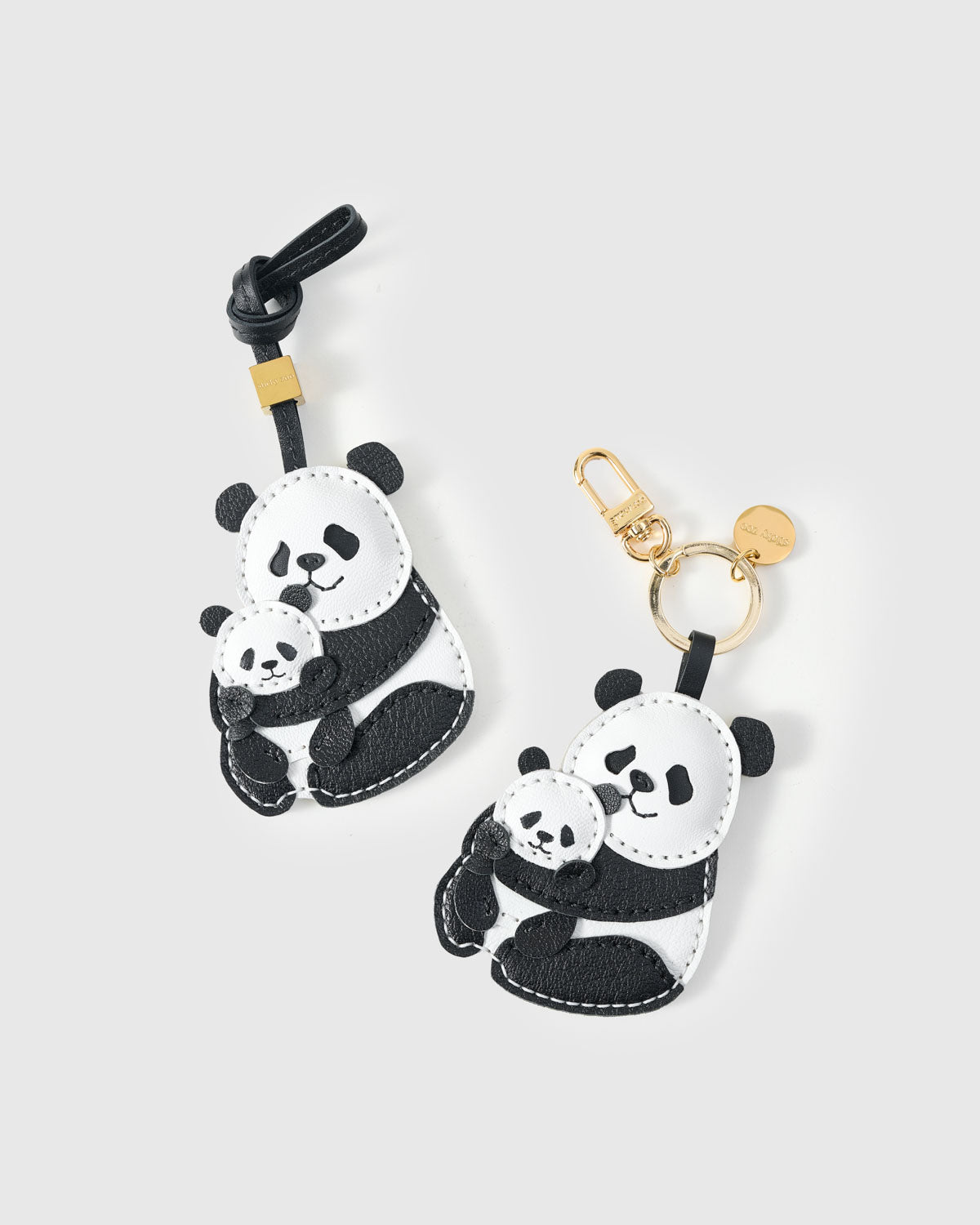 Both editions of the panda charm — leather strap loop for bags, or 18K gold-plated keychain clip.
