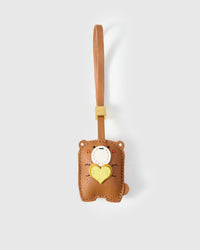 TEDDY BEAR CHARM charm handmade from French Alran genuine goatskin — A teddy bear holding a heart, eyes closed, completely at. Three days by hand. Arrives in luxury gift packaging. Designed in Amsterdam.