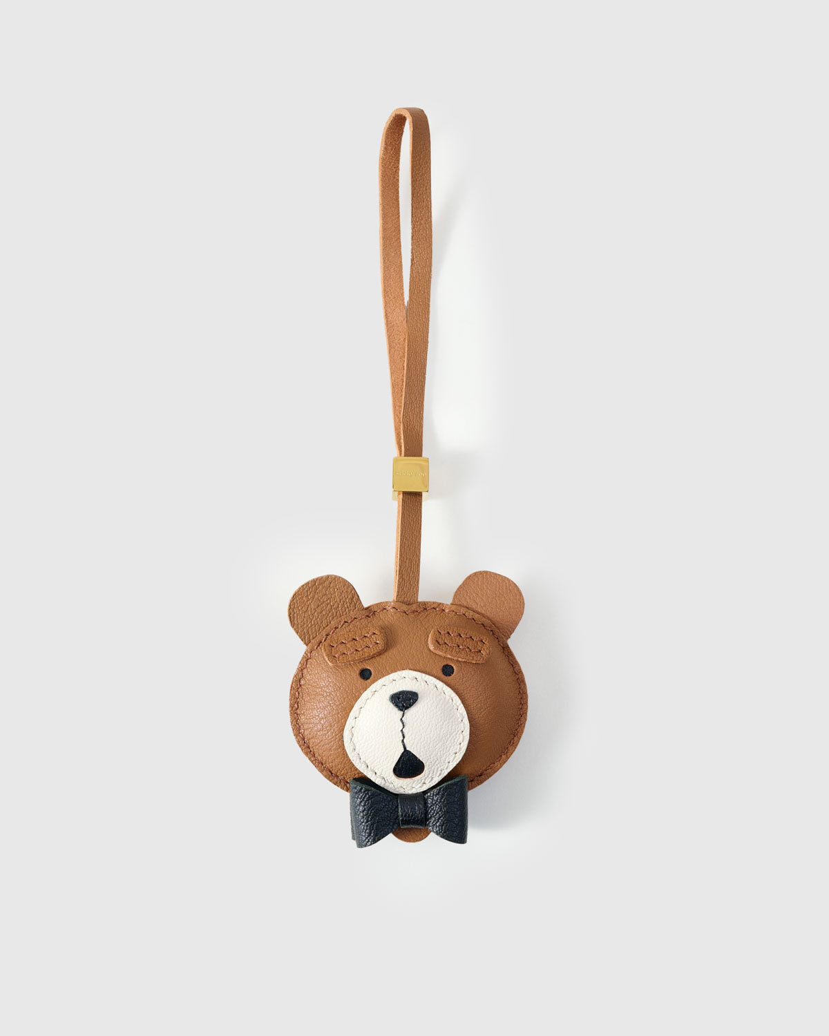 TEDDY BEAR CHARM charm handmade from French Alran genuine goatskin — A teddy bear in a bow tie. Dark navy leather, tied neatly. Three days by hand. Arrives in luxury gift packaging. Designed in Amsterdam.