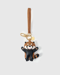 Both editions of the red panda charm — leather strap loop for bags, or 18K gold-plated keychain clip.