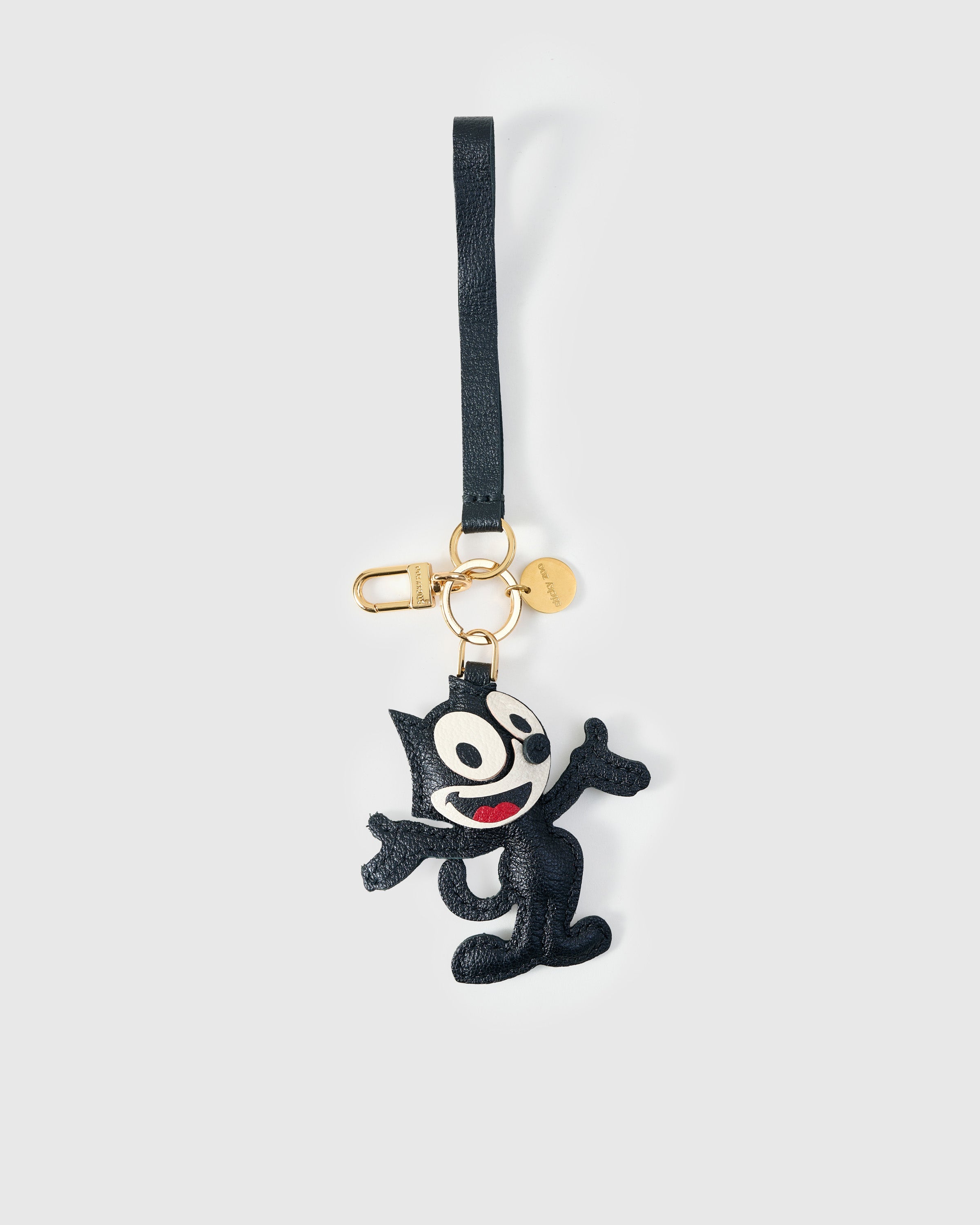 Cartoon Cat charm styled on a bag — a small, specific piece that turns a simple bag into a personal one.