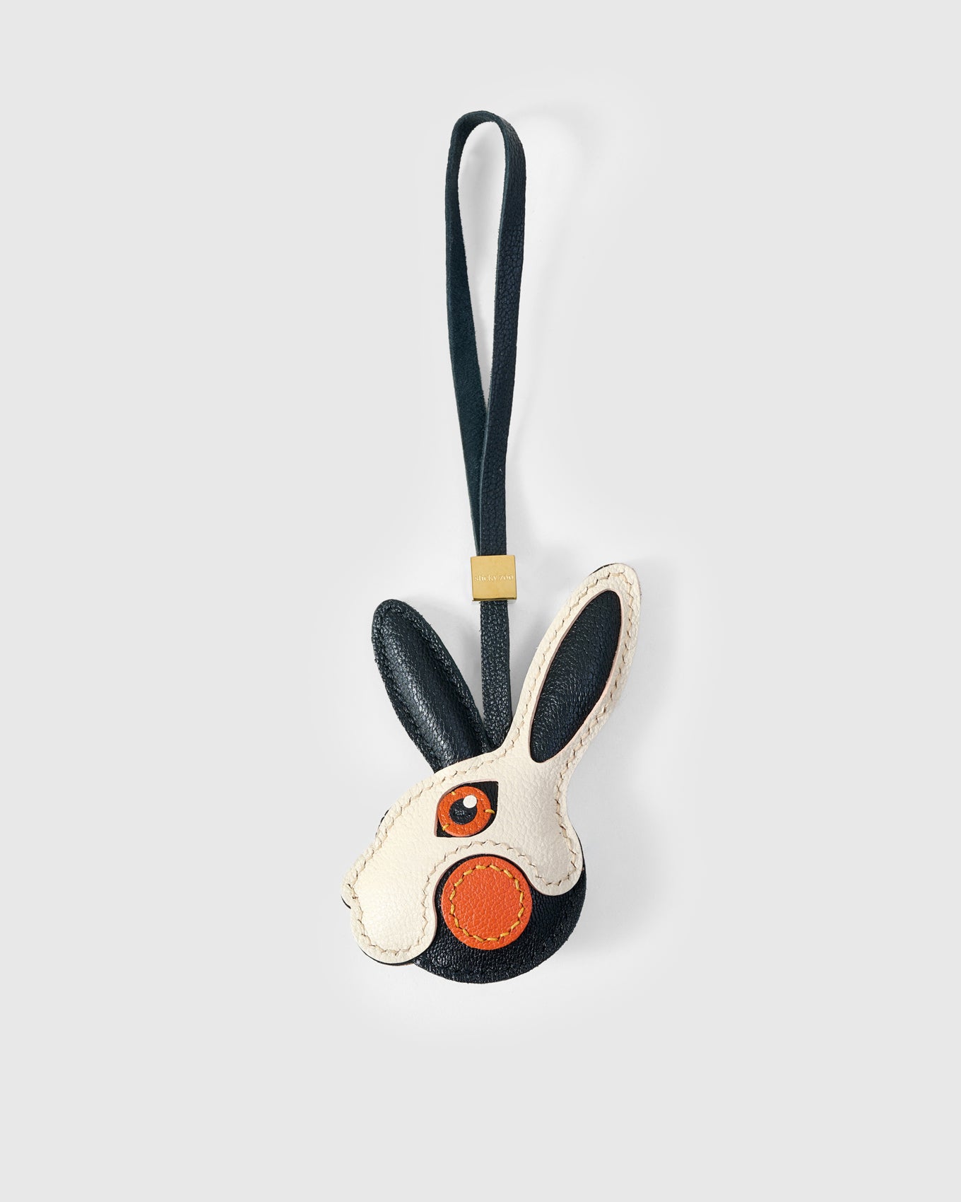 RABBIT CHARM charm handmade from French Alran genuine goatskin — A rabbit head in black and cream. One ear dark navy, one. Three days by hand. Arrives in luxury gift packaging. Designed in Amsterdam.