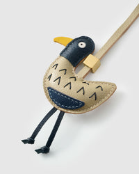 Gull charm on a bag, side angle — 5,000+ reviews across STICKYZOO. Real French leather, 3 days by hand.