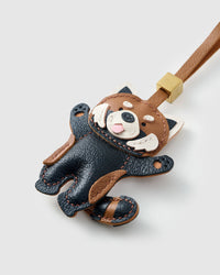 Close-up of the red panda charm — hand-cut and hand-stitched panels of French Alran goatskin. Every layer by hand.