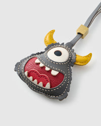 Little monster charm on a bag, side angle — loved by thousands. Real French leather, 3 days by hand.