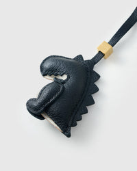 Black dinosaur charm on a bag, side angle — 5,000+ reviews across STICKYZOO. Real French leather, 3 days by hand.