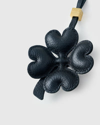 Close-up of STICKYZOO Lucky Clover Charm — full-grain French Alran goatskin from Tarn, France. Padded heart-shaped petals. 3-day handmade piece.