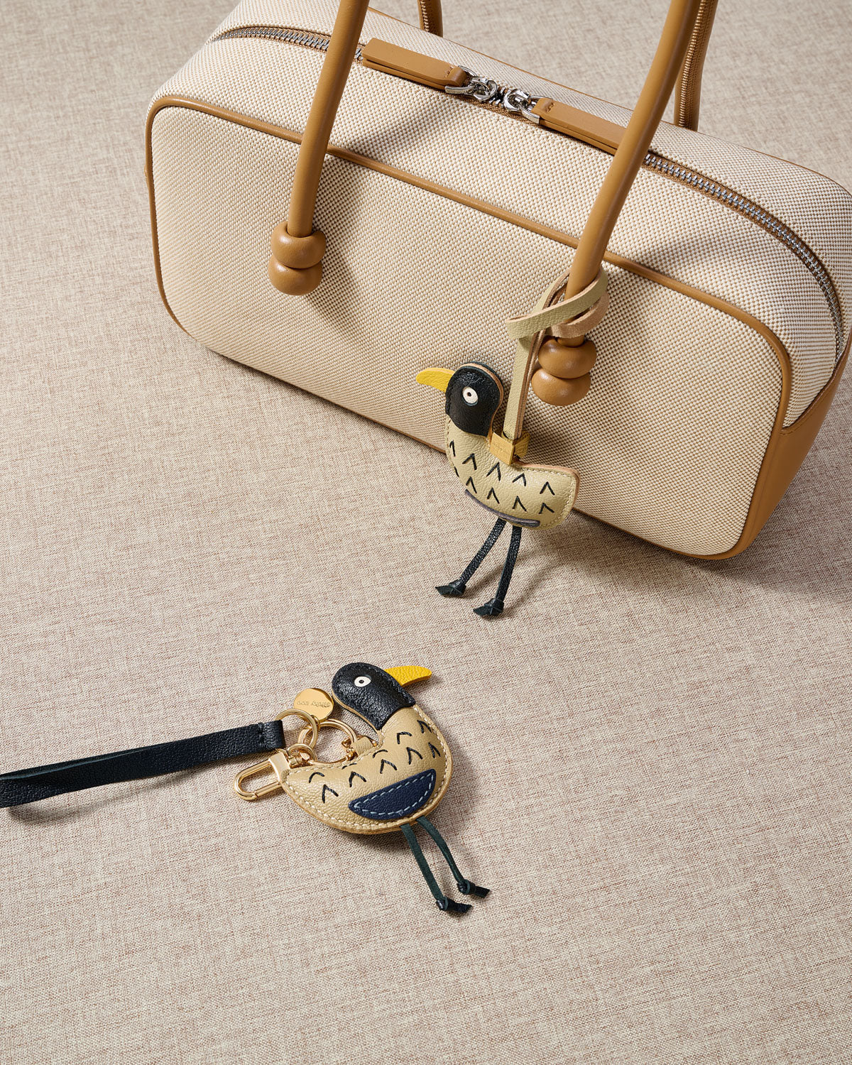 Close-up of the gull — hand-stitched arrow feather detail, navy chest accent, yellow beak. Every panel by hand.