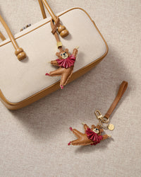 Close-up of the ballet bear charm — hand-cut and hand-stitched panels of French Alran goatskin. Every layer by hand.