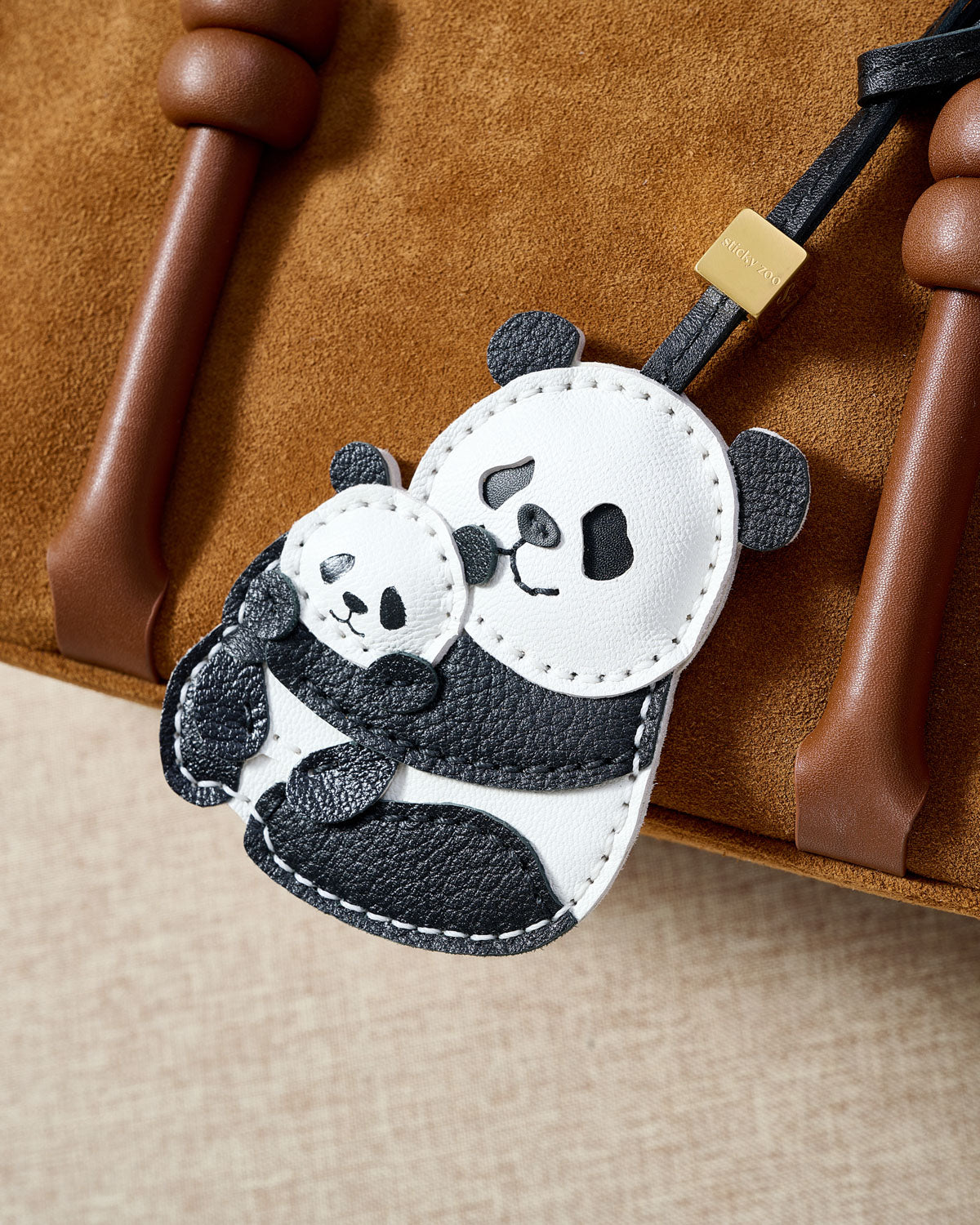 PANDA CHARM charm styled on a bag — a small, specific piece that turns a simple bag into a personal one.
