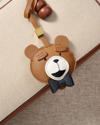 TEDDY BEAR CHARM charm styled on a bag — a small, specific piece that turns a simple bag into a personal one.