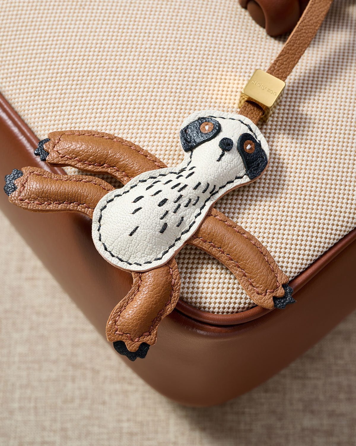 SLOTH CHARM charm styled on a bag — a small, specific piece that turns a simple bag into a personal one.