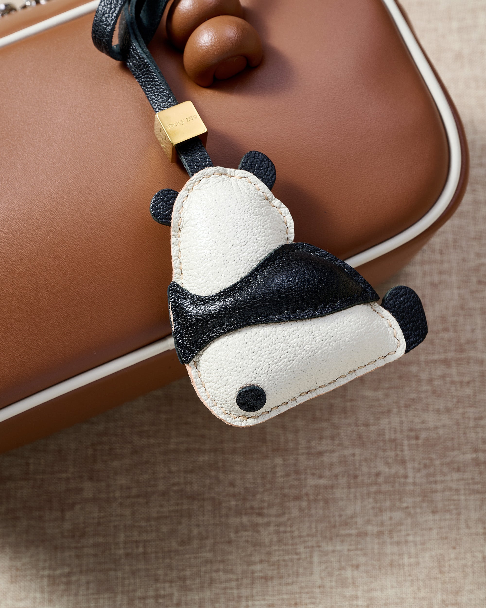 PANDA CHARM charm styled on a bag — a small, specific piece that turns a simple bag into a personal one.