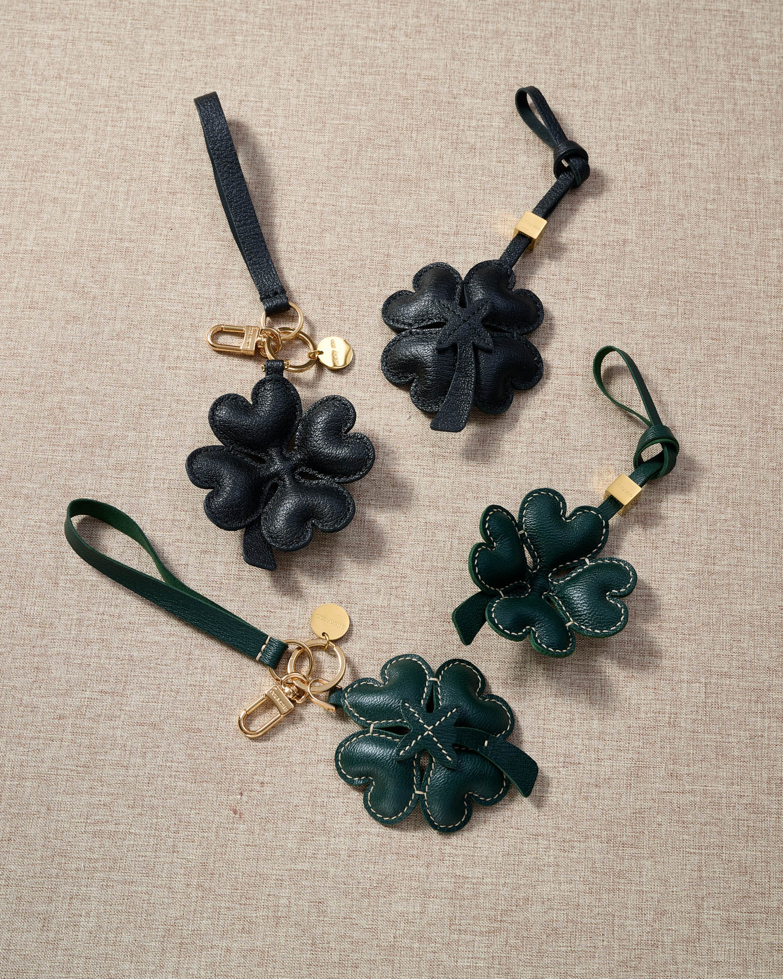 STICKYZOO Lucky Clover Charm — dual attachment option: leather strap for bags or keychain clip. French Alran goatskin.