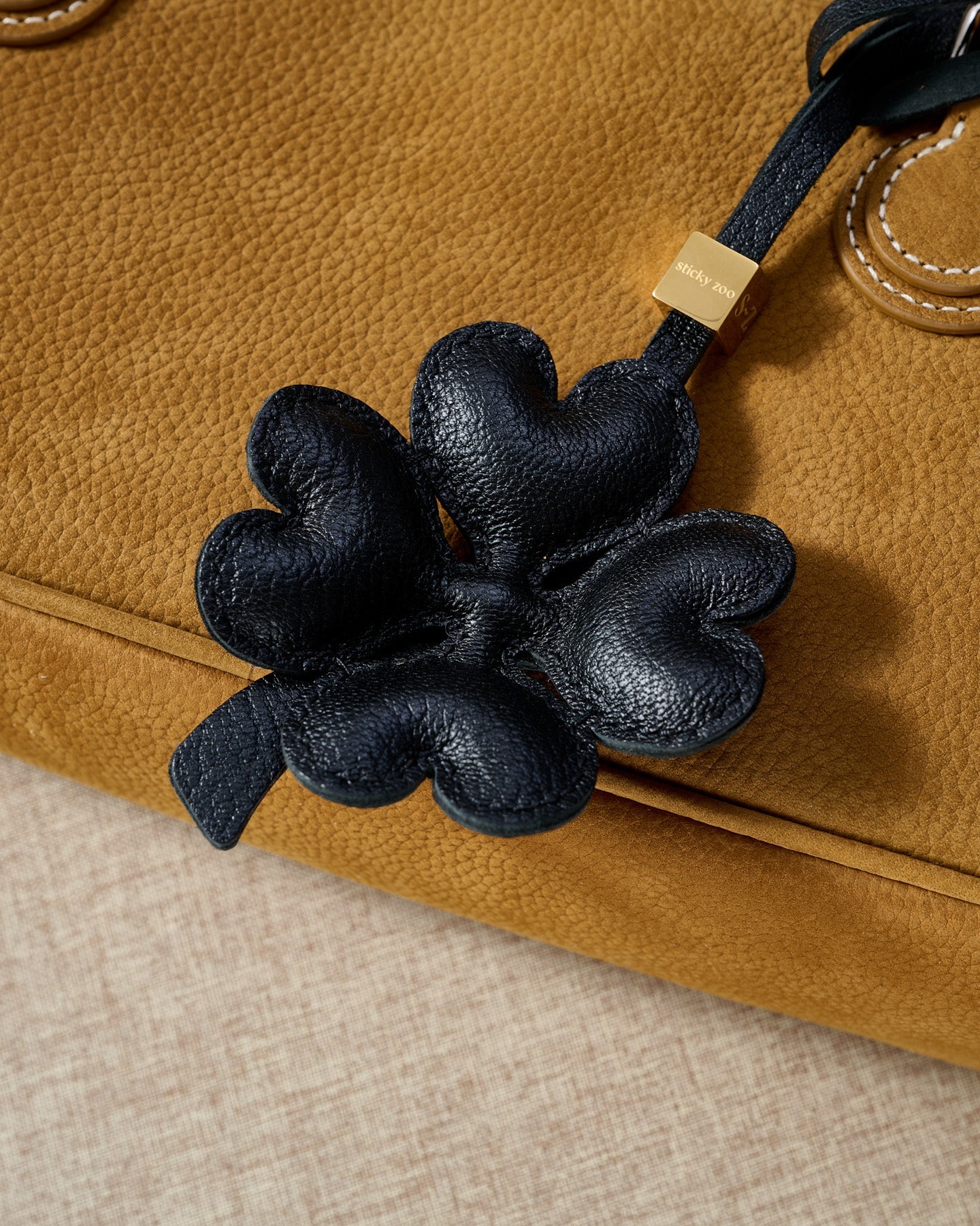 STICKYZOO Lucky Clover Charm in black padded 3D — handmade French Alran goatskin with 18K gold-plated hardware. Arrives gift-ready.