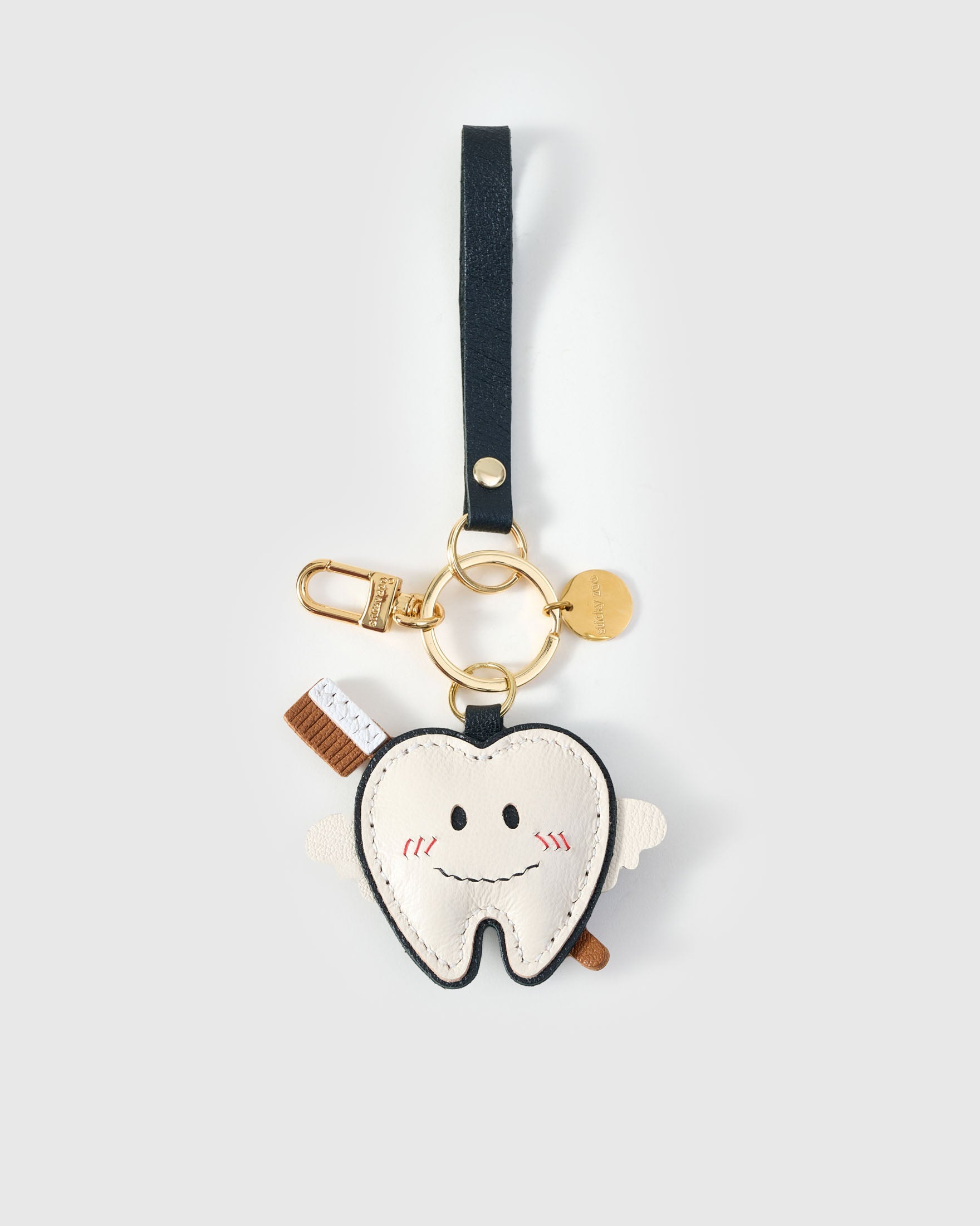 Tooth fairy charm on a bag, side angle — rated 4.9★ by thousands of buyers. Real French Alran leather, 3 days by hand.