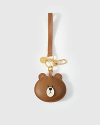 Both editions of the cuddly bear charm — leather strap loop for bags, or 18K gold-plated keychain clip.