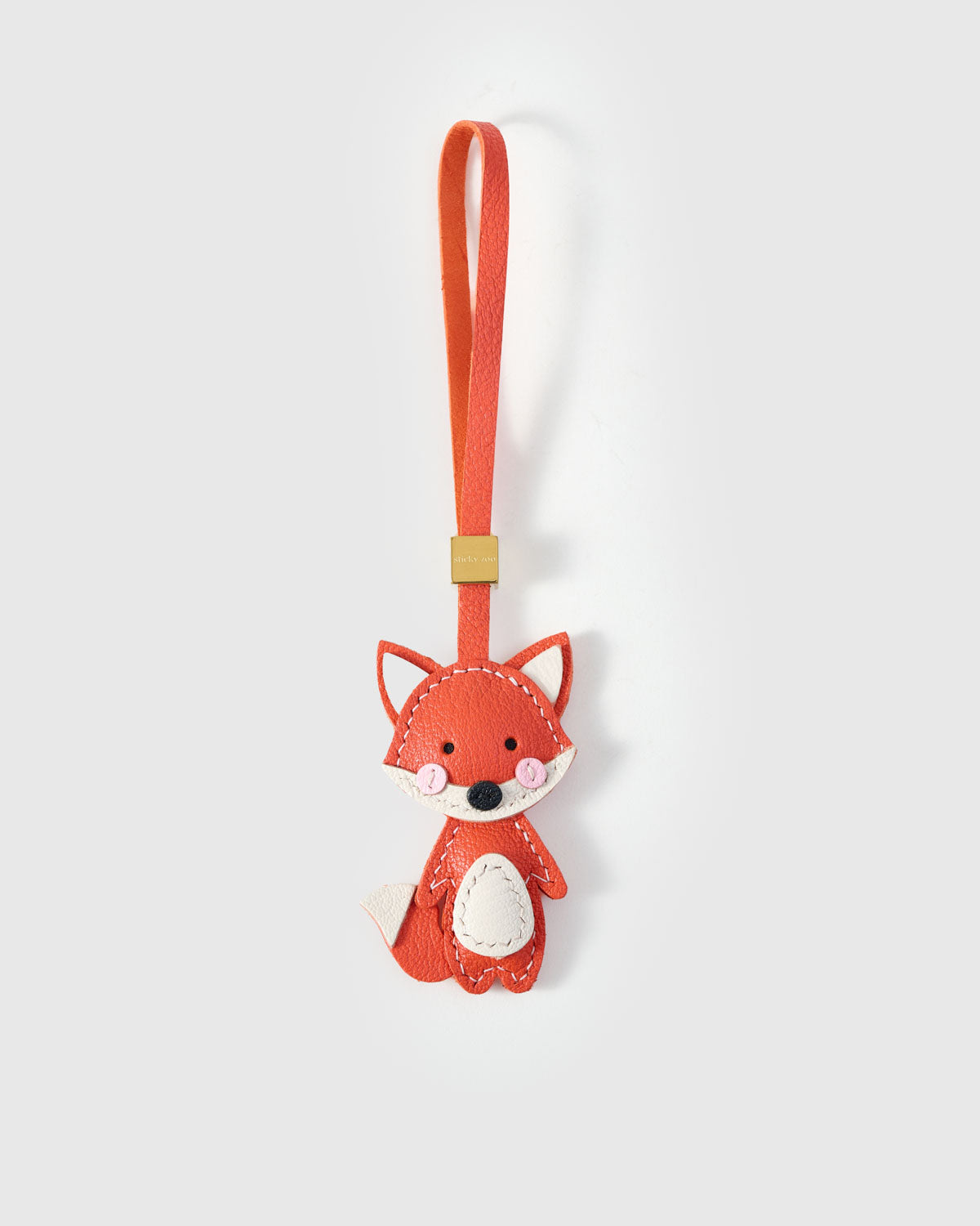 FOX CHARM charm handmade from French Alran genuine goatskin — A full-body fox in vivid orange. Sitting upright, tail. Three days by hand. Arrives in luxury gift packaging. Designed in Amsterdam.