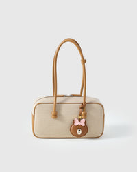 CUDDLY BEAR CHARM charm styled on a bag — a small, specific piece that turns a simple bag into a personal one.