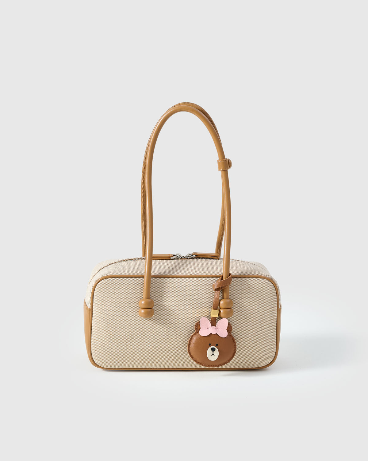 CUDDLY BEAR CHARM charm styled on a bag — a small, specific piece that turns a simple bag into a personal one.