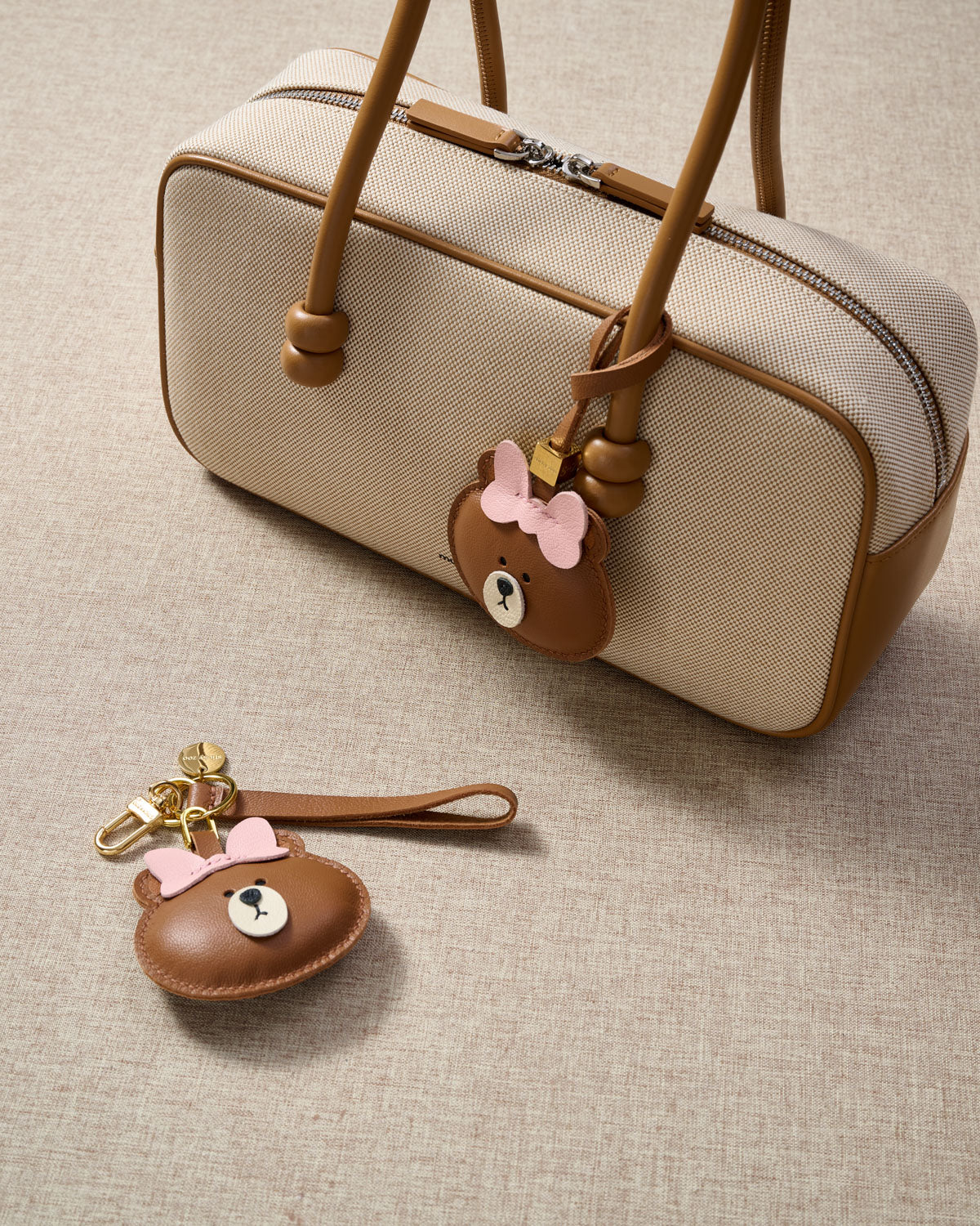 Close-up of the cuddly bear charm — hand-cut and hand-stitched panels of French Alran goatskin. Every layer by hand.