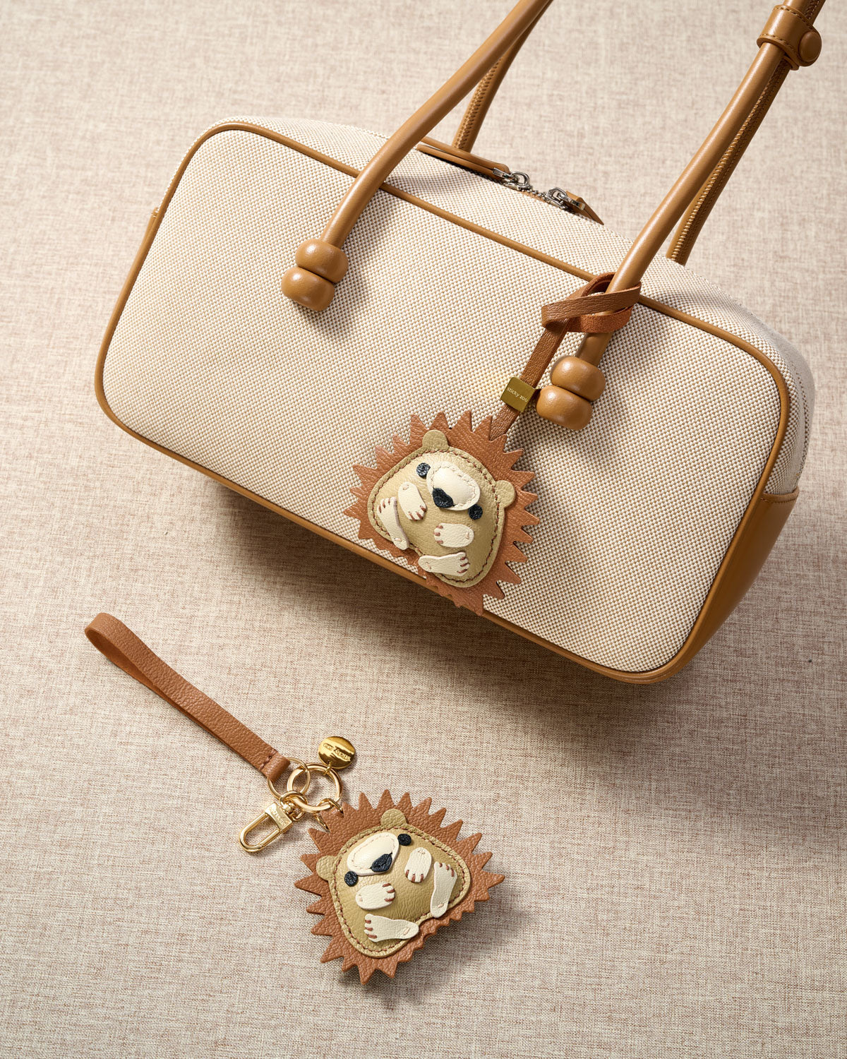 Close-up of the hedgehog charm — hand-cut and hand-stitched panels of French Alran goatskin. Every layer by hand.