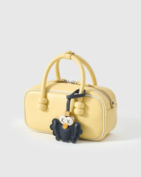 Both editions of black Hootie — leather strap loop for bags, or 18K gold-plated keychain clip.