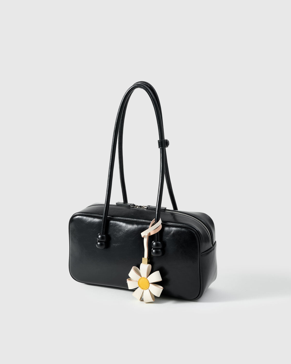 STICKYZOO Daisy Bag Charm with engraved gold hardware cube — handmade French Alran goatskin, white with yellow centre.
