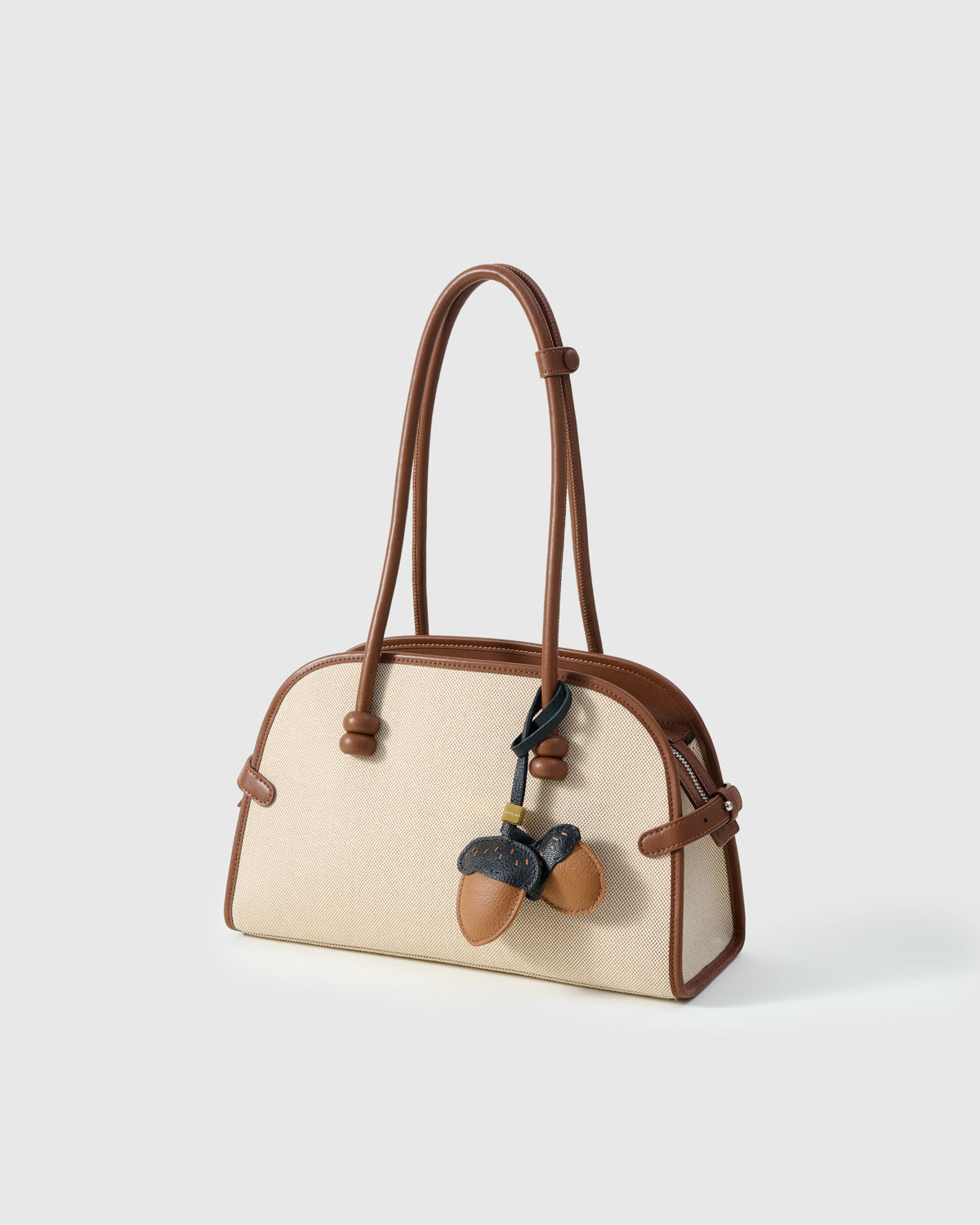 STICKYZOO Acorns Charm with engraved gold hardware cube — handmade French Alran goatskin, warm tan with dark navy caps.