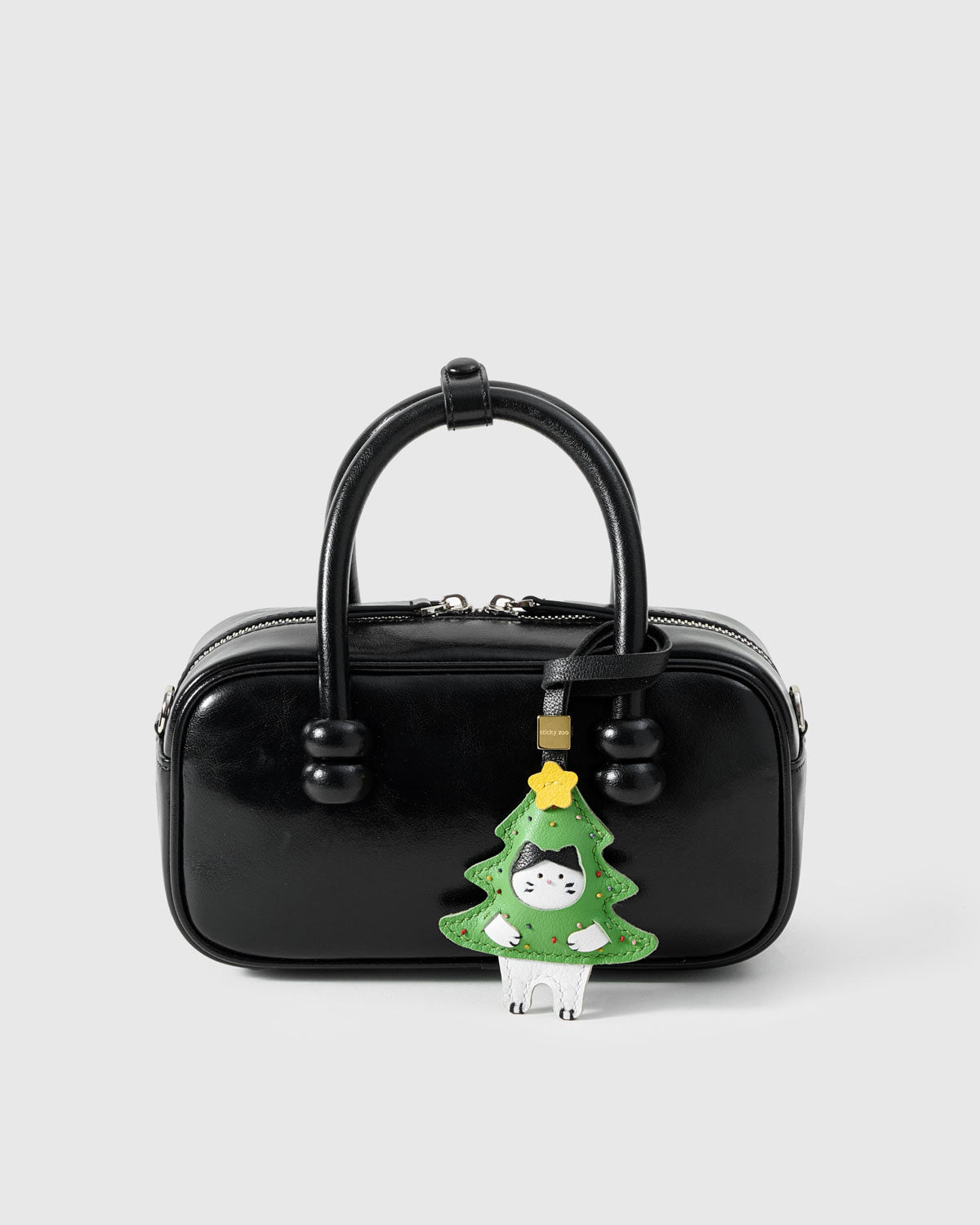 Kitten In Christmas Tree on a bag, side angle — loved by thousands of cat people. Real French leather, 3 days by hand.