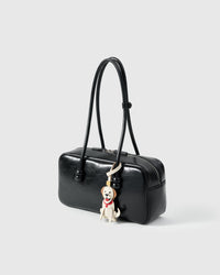 Golden Retriever leather bag charm shown in both attachment options — handmade French Alran goatskin, dual attachment. STICKYZOO Amsterdam design.