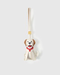 Handmade Golden Retriever leather bag charm by STICKYZOO — sitting pose in cream with tan ears, hand-cut and hand-stitched French Alran goatskin over 5 days. Designed in Amsterdam.