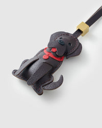 Handmade Golden Retriever leather bag charm clipped to a handbag — French Alran goatskin, 5-day artisan build. STICKYZOO.