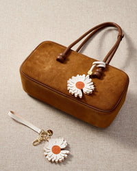 Close-up of STICKYZOO Daisy Charm — full-grain French Alran goatskin from Tarn, France. Layered daisy petals. 3-day handmade piece.
