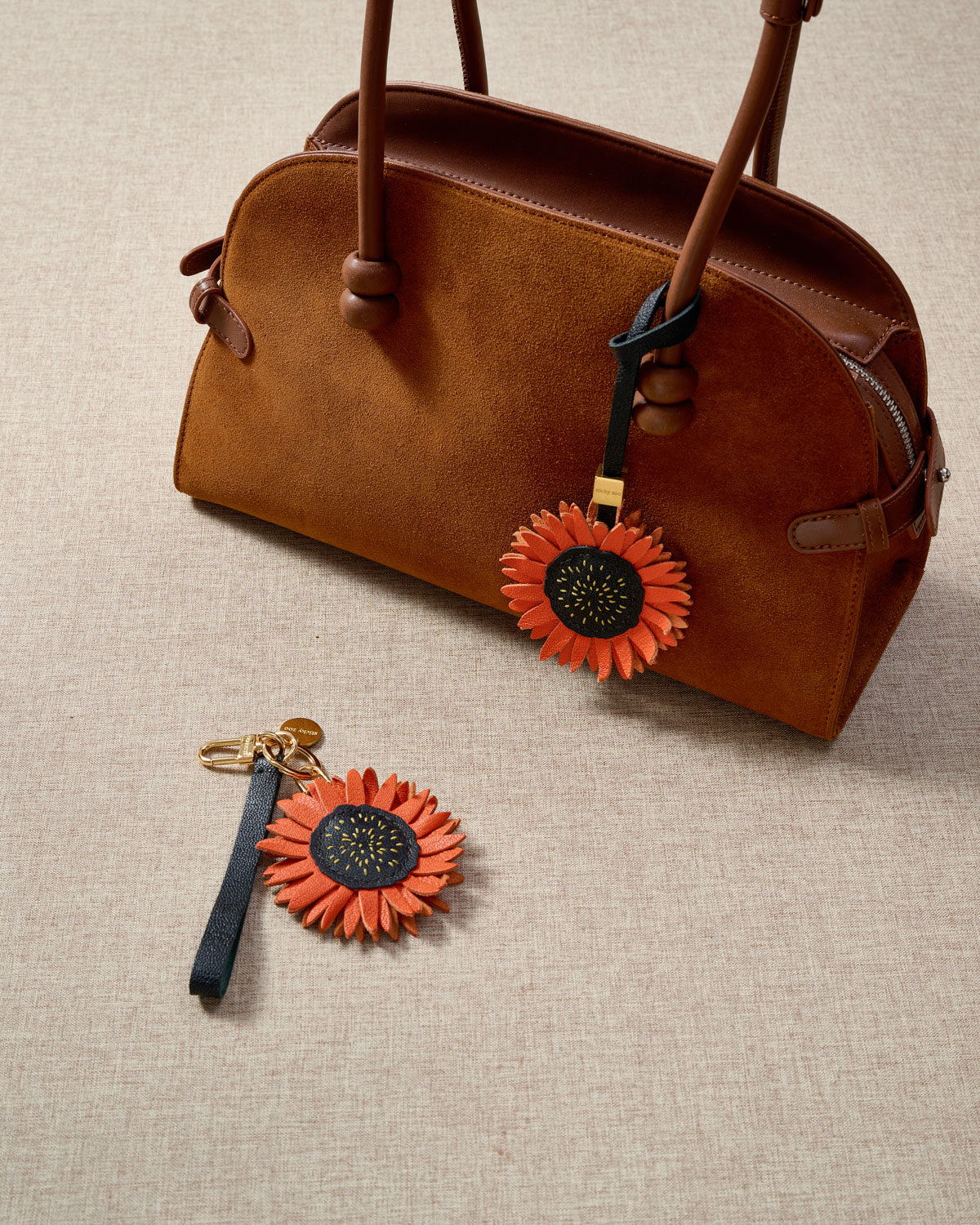 Close-up of STICKYZOO Sunflower Charm — full-grain French Alran goatskin from Tarn, France. Layered sunflower petals with stitched centre. 3-day handmade piece.