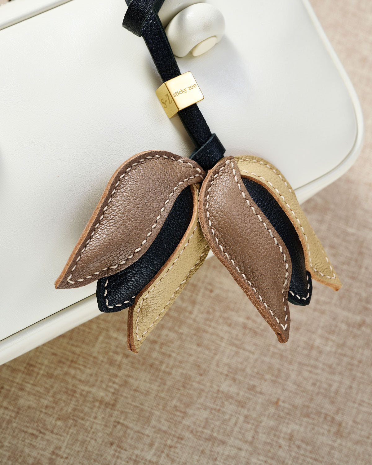 STICKYZOO Tulip Charm — hand-cut, hand-stitched 3D dimensional tulip with overlapping petals in French Alran goatskin. Designed in Amsterdam.