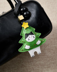 Kitten In Christmas Tree charm styled on a bag — a small, specific piece that turns a simple bag into a personal one.