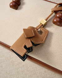 ELEPHANT CHARM charm styled on a bag — a small, specific piece that turns a simple bag into a personal one.