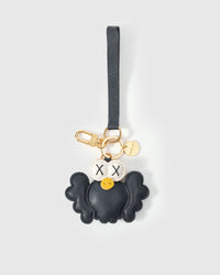 Black Hootie charm styled on a bag, front — a small, specific piece that turns a simple bag into a personal one.