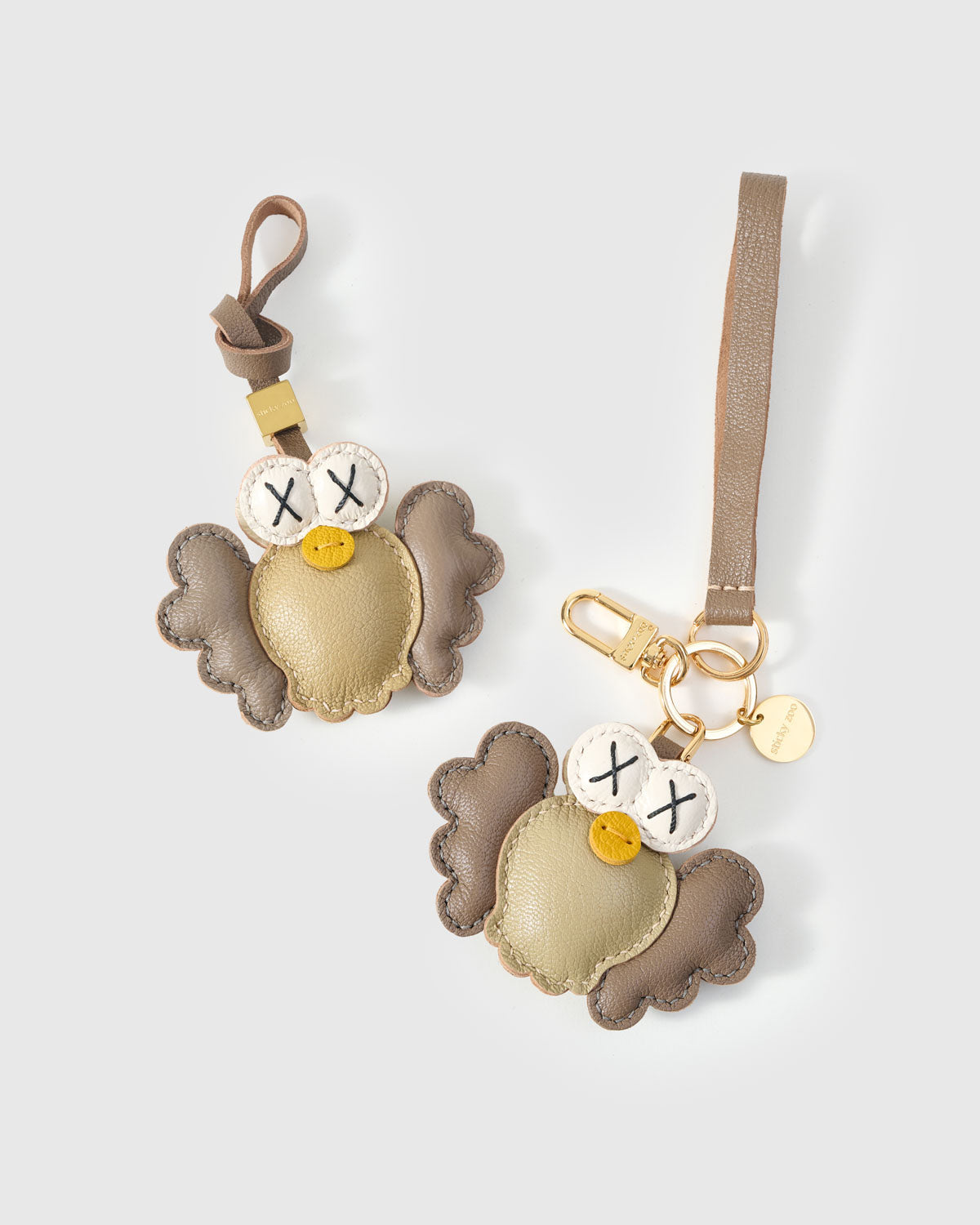 Gold Hootie charm on a bag, side angle — loved by thousands of owl lovers. Real French leather, 3 days by hand.