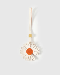 STICKYZOO Daisy Charm — white French Alran goatskin petals in two layered tiers with orange suede centre disc, 18K gold-plated hardware. 3-day handmade piece.