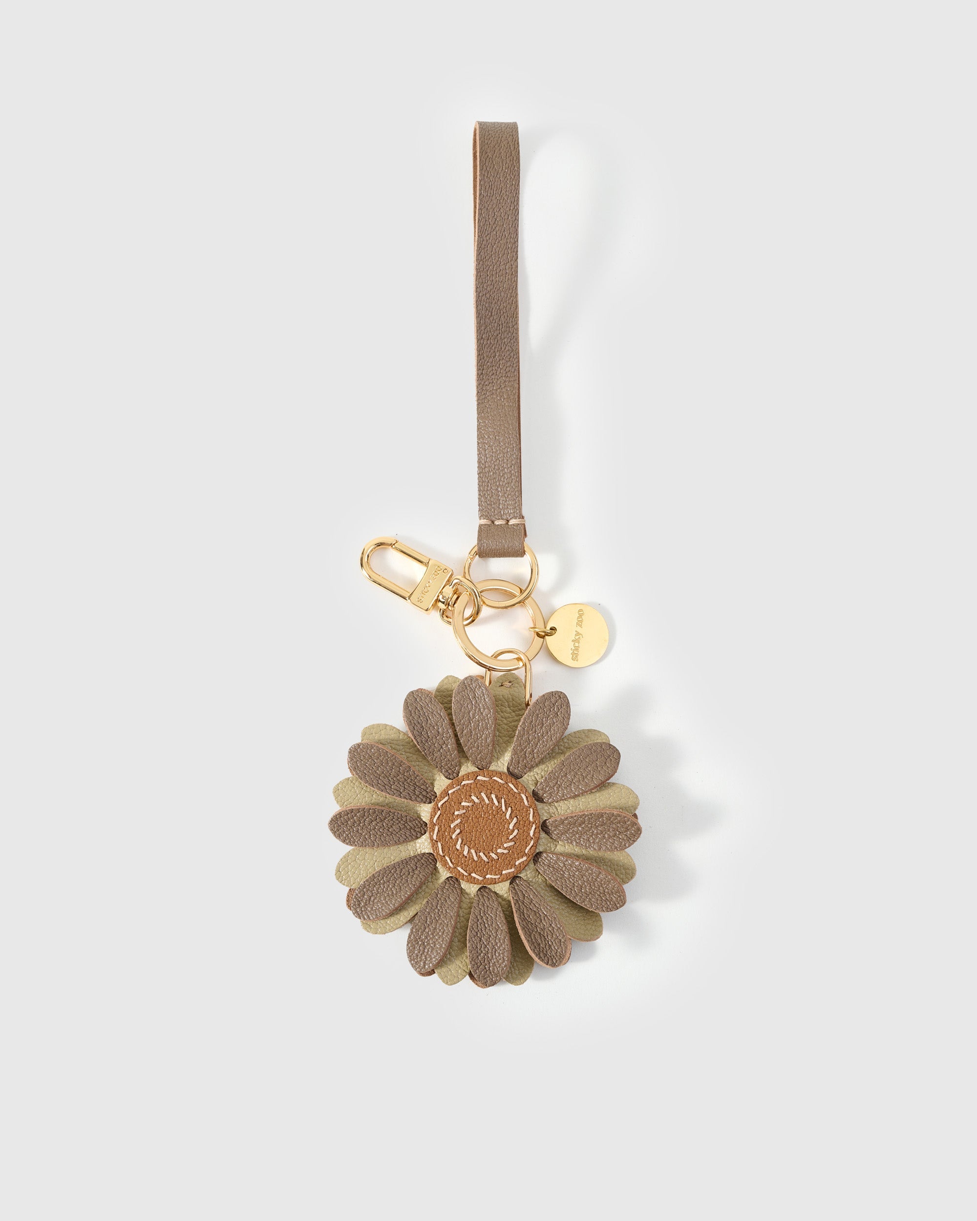 Close-up of STICKYZOO Daisy Charm — full-grain French Alran goatskin from Tarn, France. Layered daisy petals with tan centre. 3-day handmade piece.
