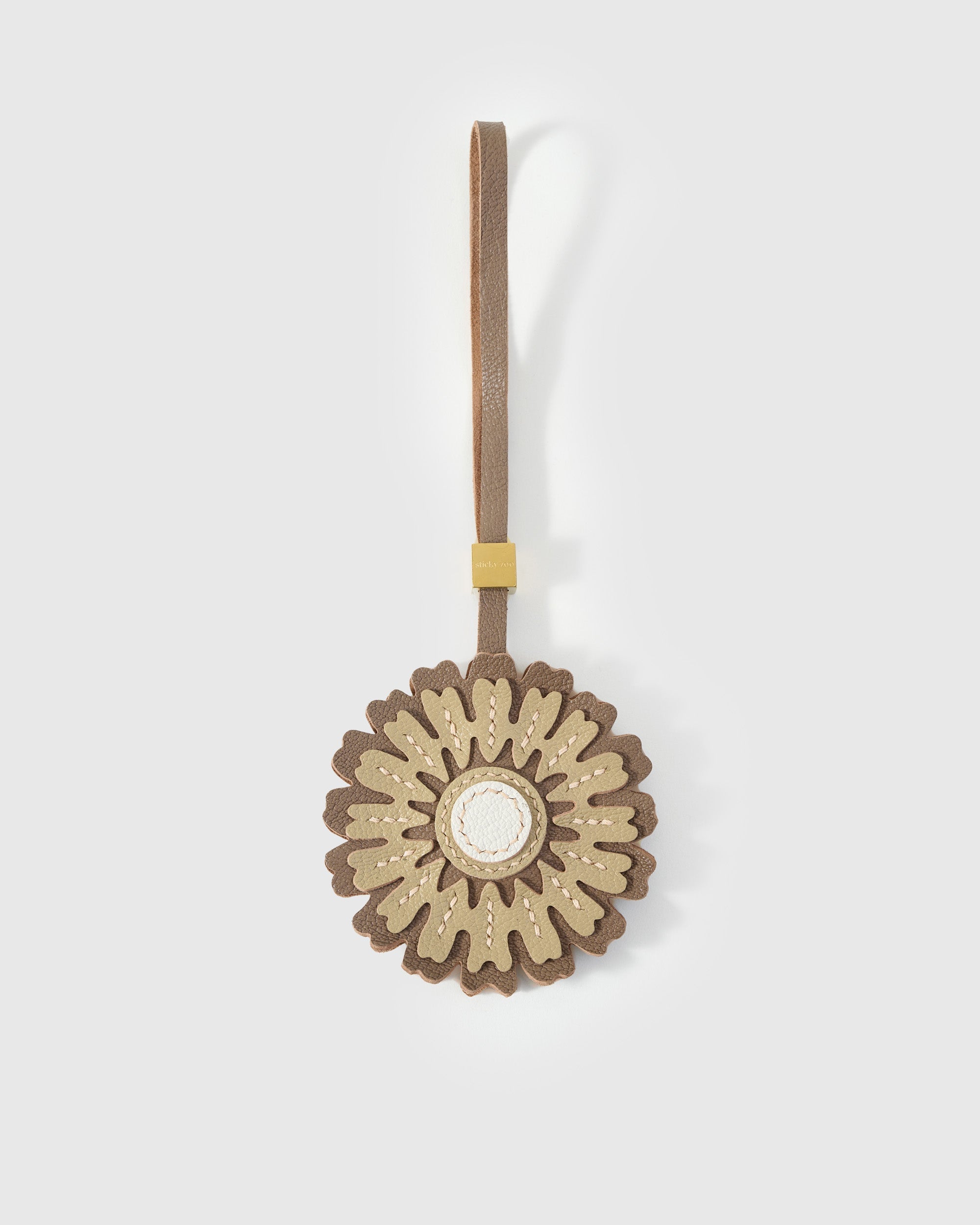 STICKYZOO Sunflower Charm in light — cream and olive French Alran goatskin petals with white centre disc, brown strap. 3-day handmade piece.